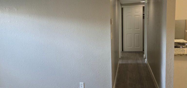 Interior painting and flooring Hallway with painted walls and wood-look flooring